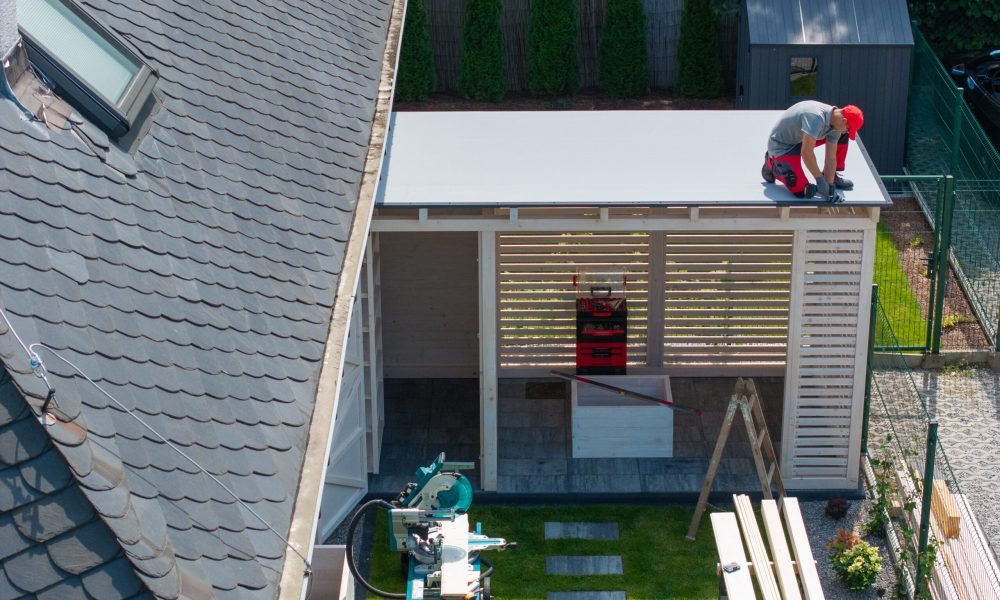 Construction Worker Installing Roof On Patio Gazebo Structure